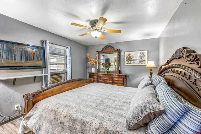 a bedroom with a large bed and a chandelier