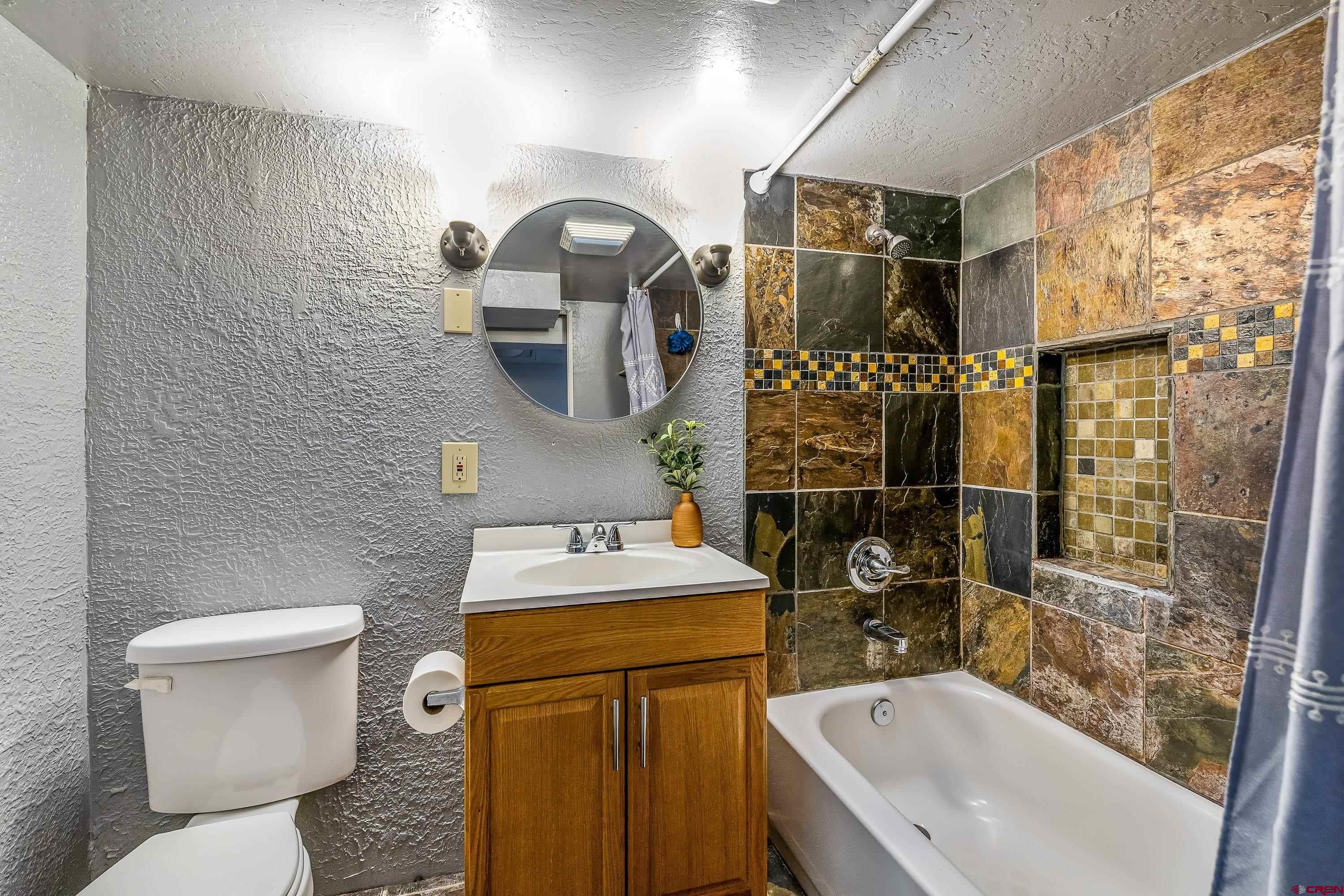 645 Leon Street Delta, CO 81416 - Photo 20 of 28 a bathroom with a sink toilet and shower