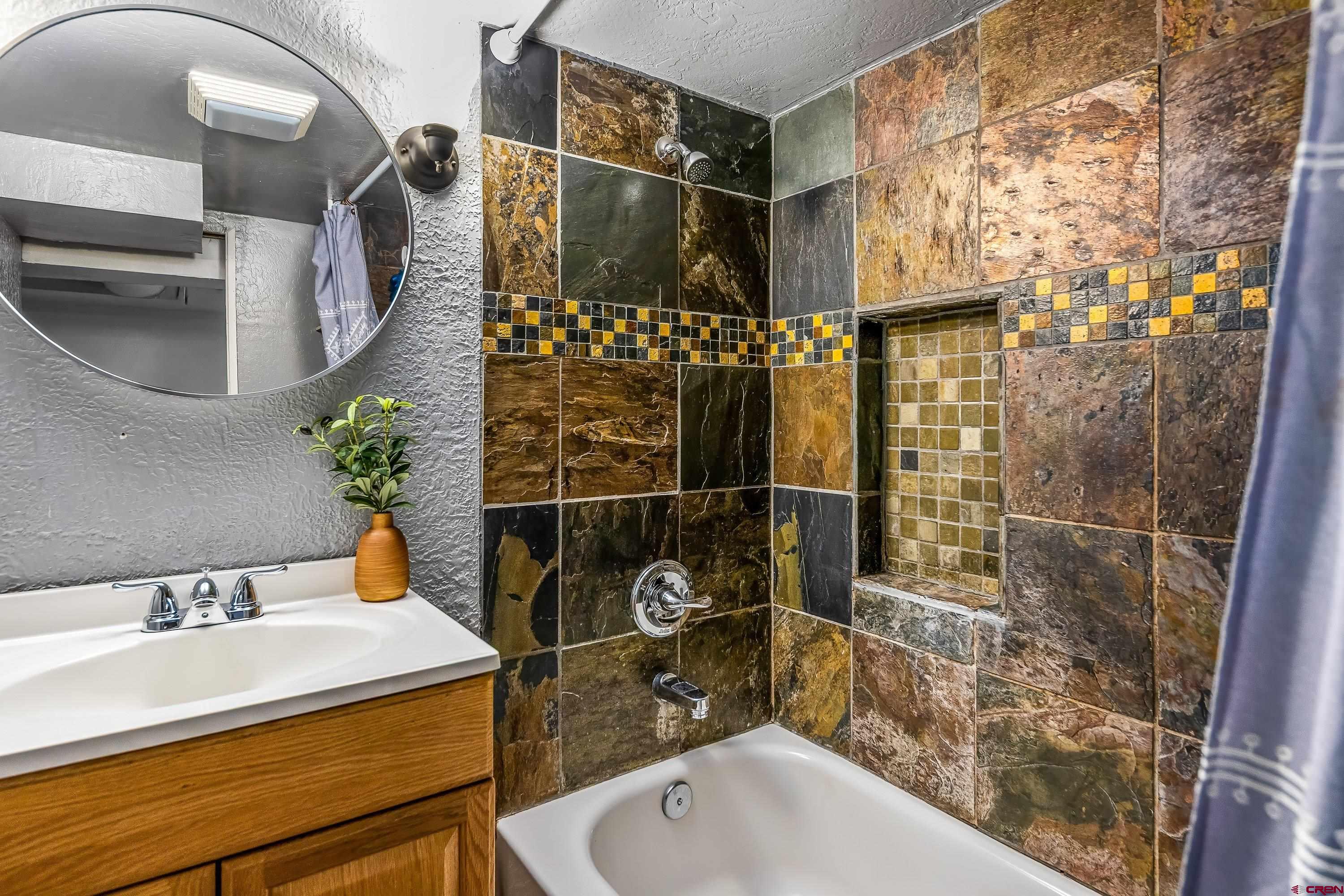 645 Leon Street Delta, CO 81416 - Photo 21 of 28 a bathroom with a sink toilet and shower