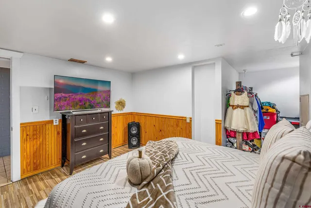 a bedroom with a bed and a flat screen tv