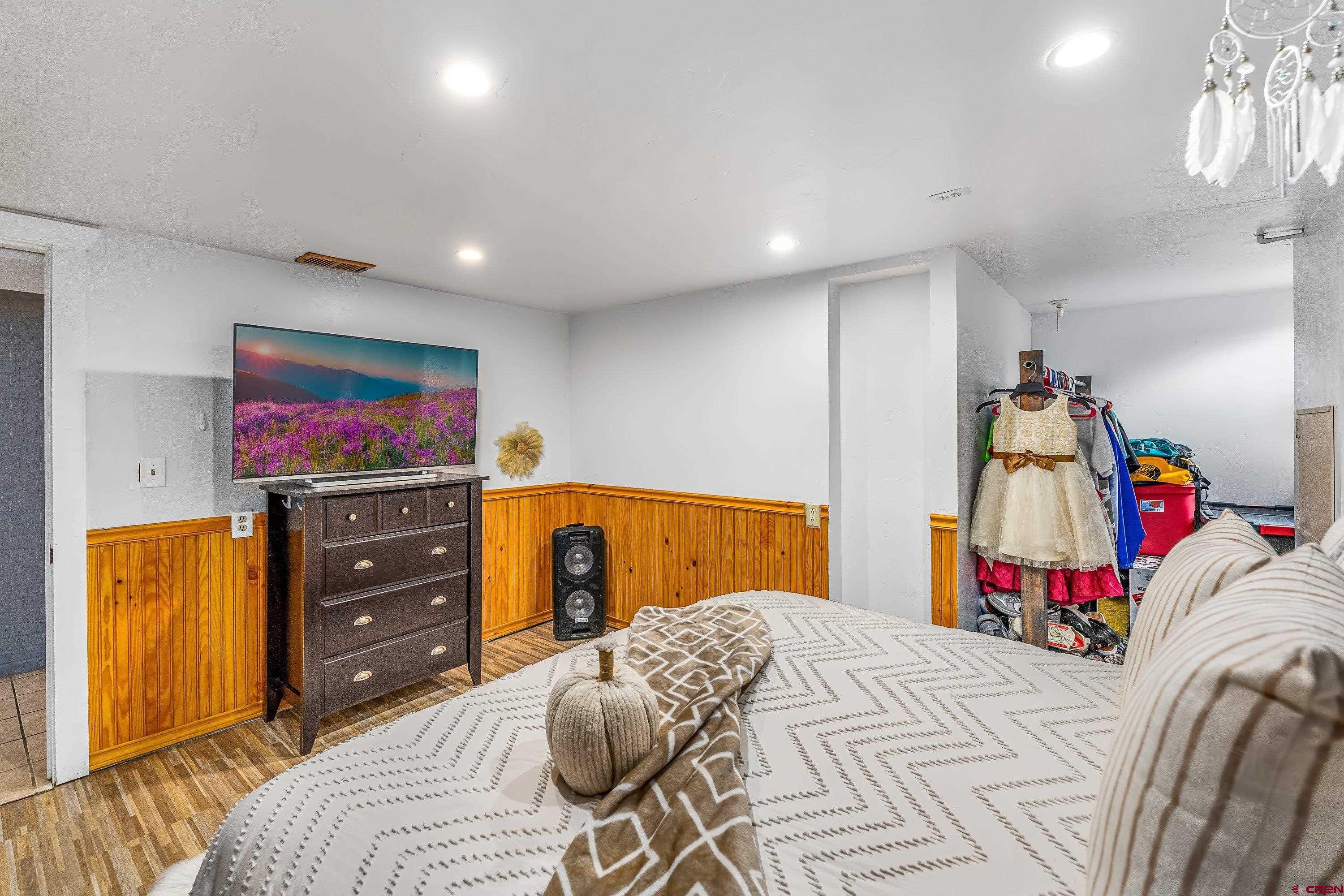 645 Leon Street Delta, CO 81416 - Photo 23 of 28 a bedroom with a bed and a flat screen tv