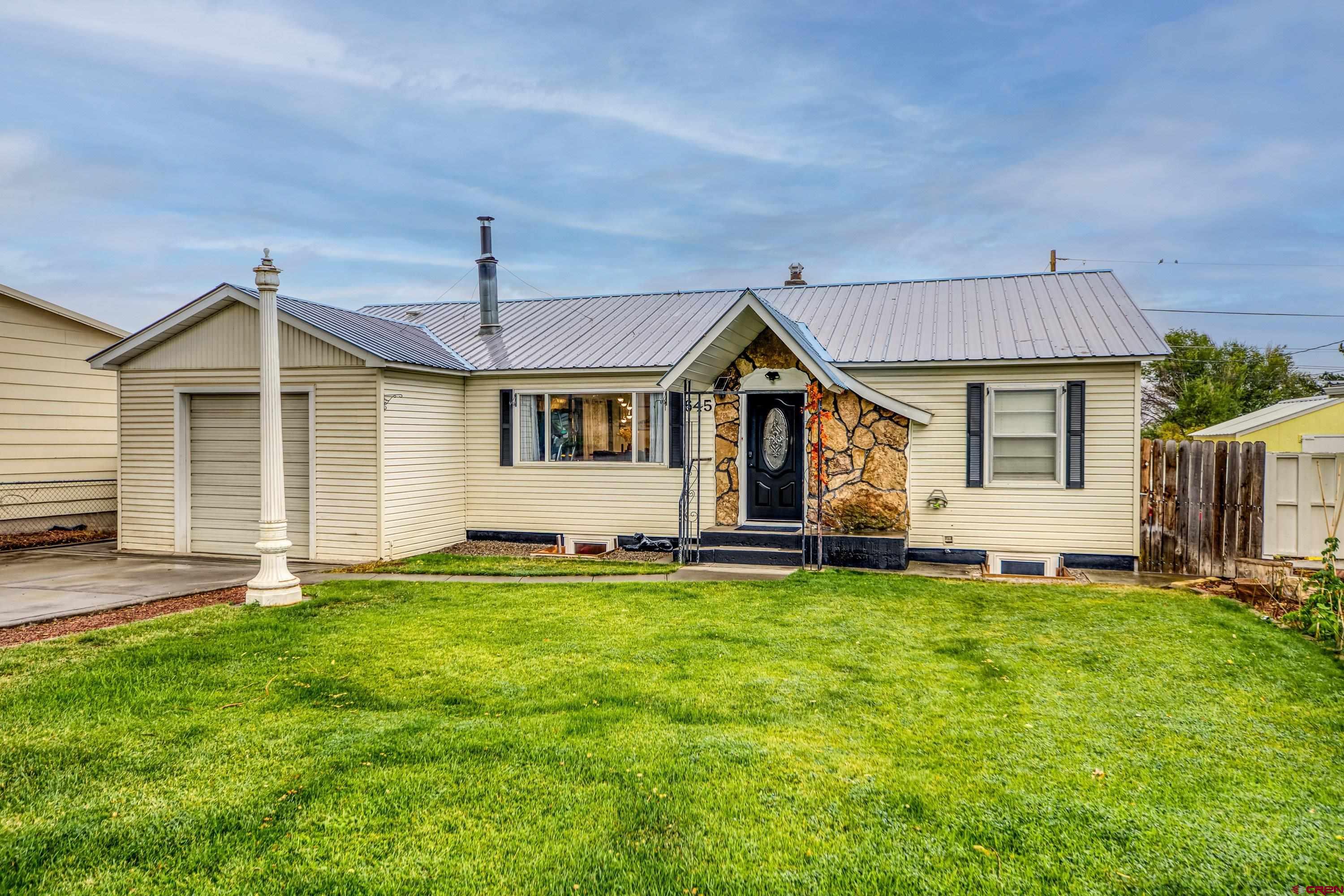 645 Leon Street Delta, CO 81416 - Photo 26 of 28 a front view of a house with a garden