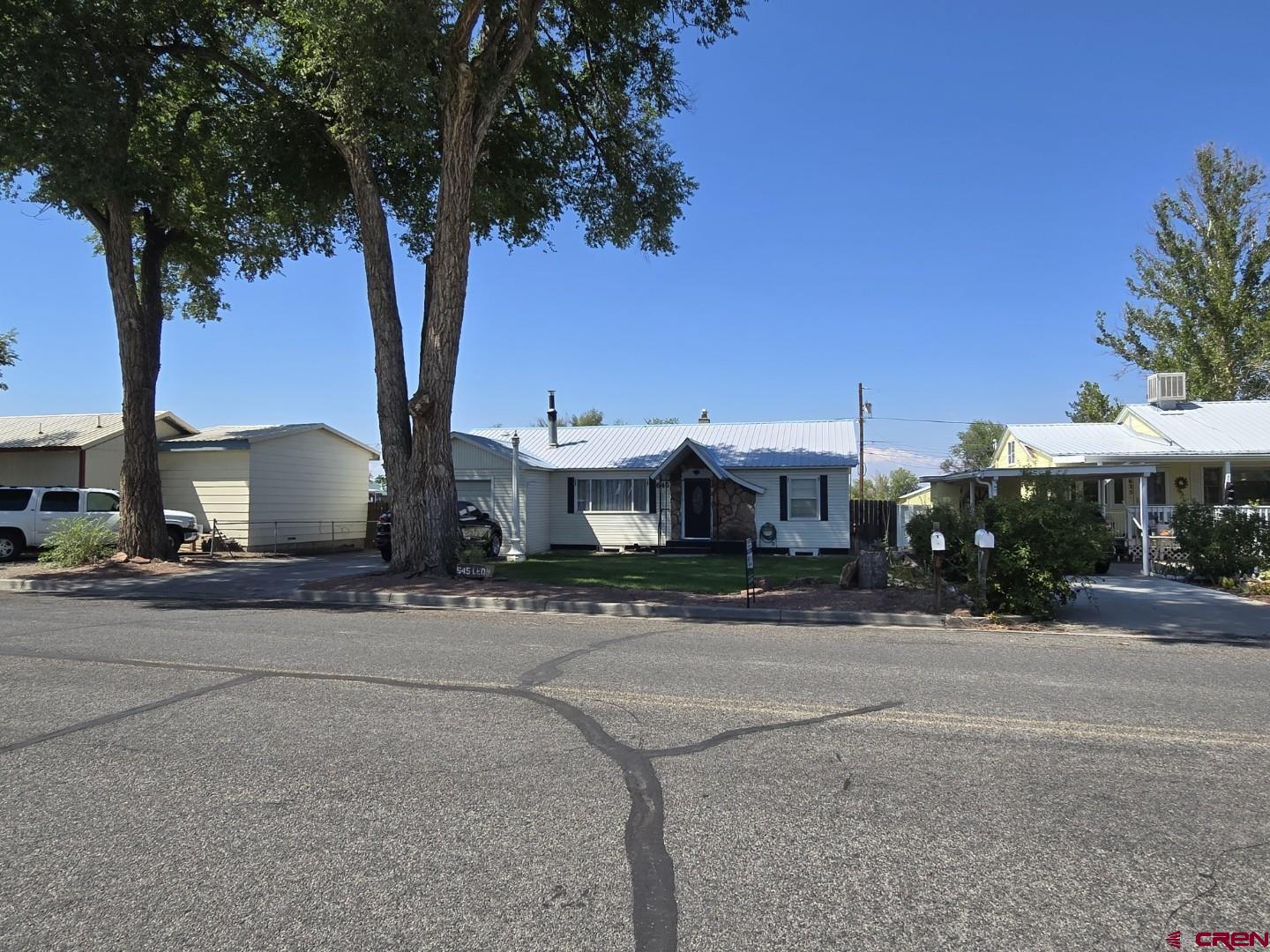 645 Leon Street Delta, CO 81416 - Photo 28 of 28 a front view of a house with a yard and garage