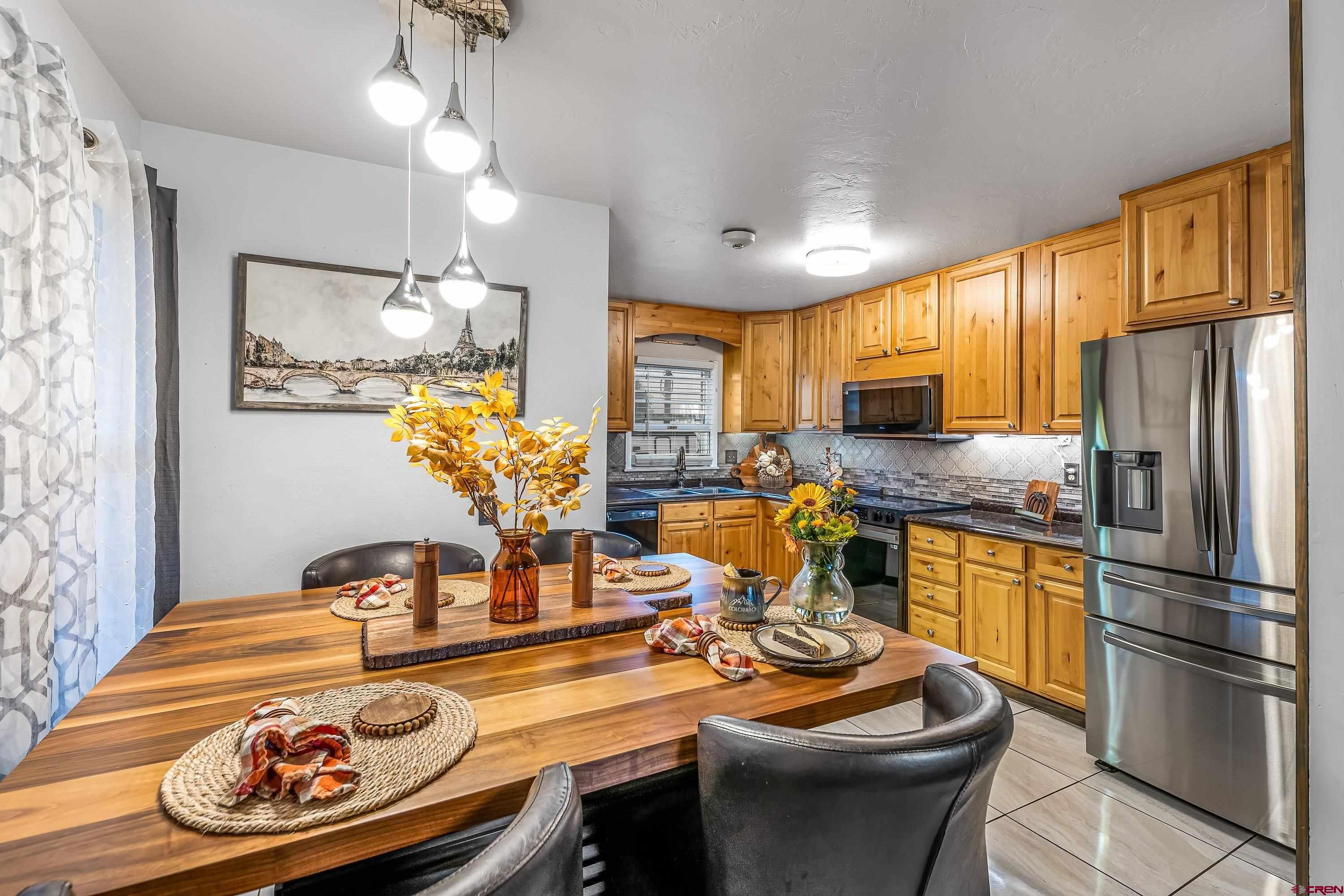 645 Leon Street Delta, CO 81416 - Photo 3 of 28 a kitchen with a refrigerator and a stove