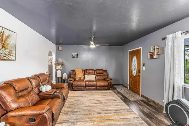 a spacious bedroom with a bed couch and a window