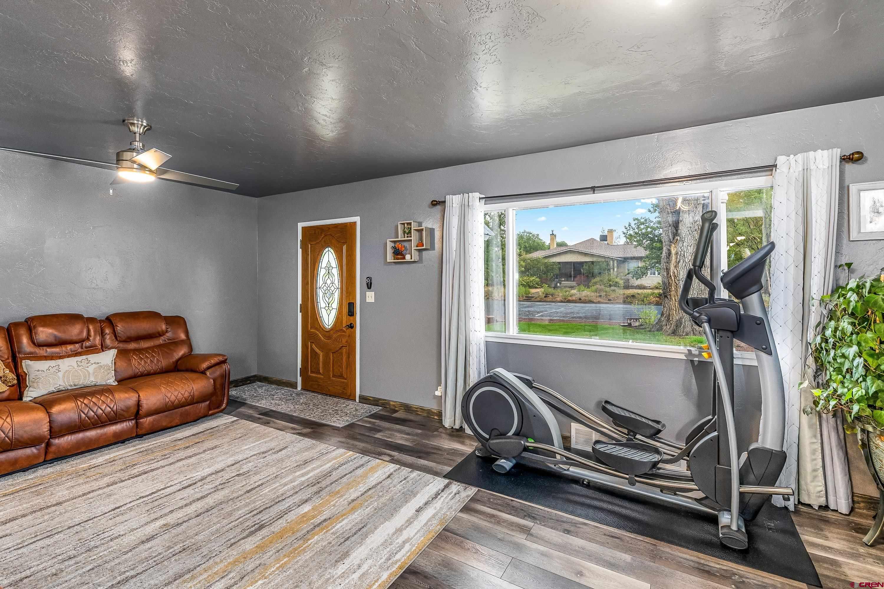 645 Leon Street Delta, CO 81416 - Photo 9 of 28 a room with gym equipment and wooden floor