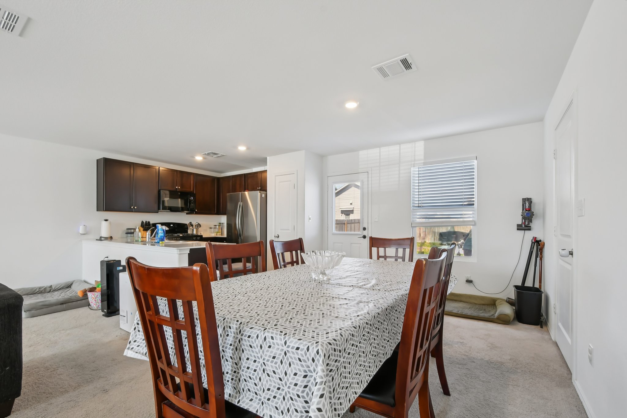 14116 Mussel Run Elgin, TX 78621 - Photo 12 of 40 Dining area with light colored carpet and recessed lighting