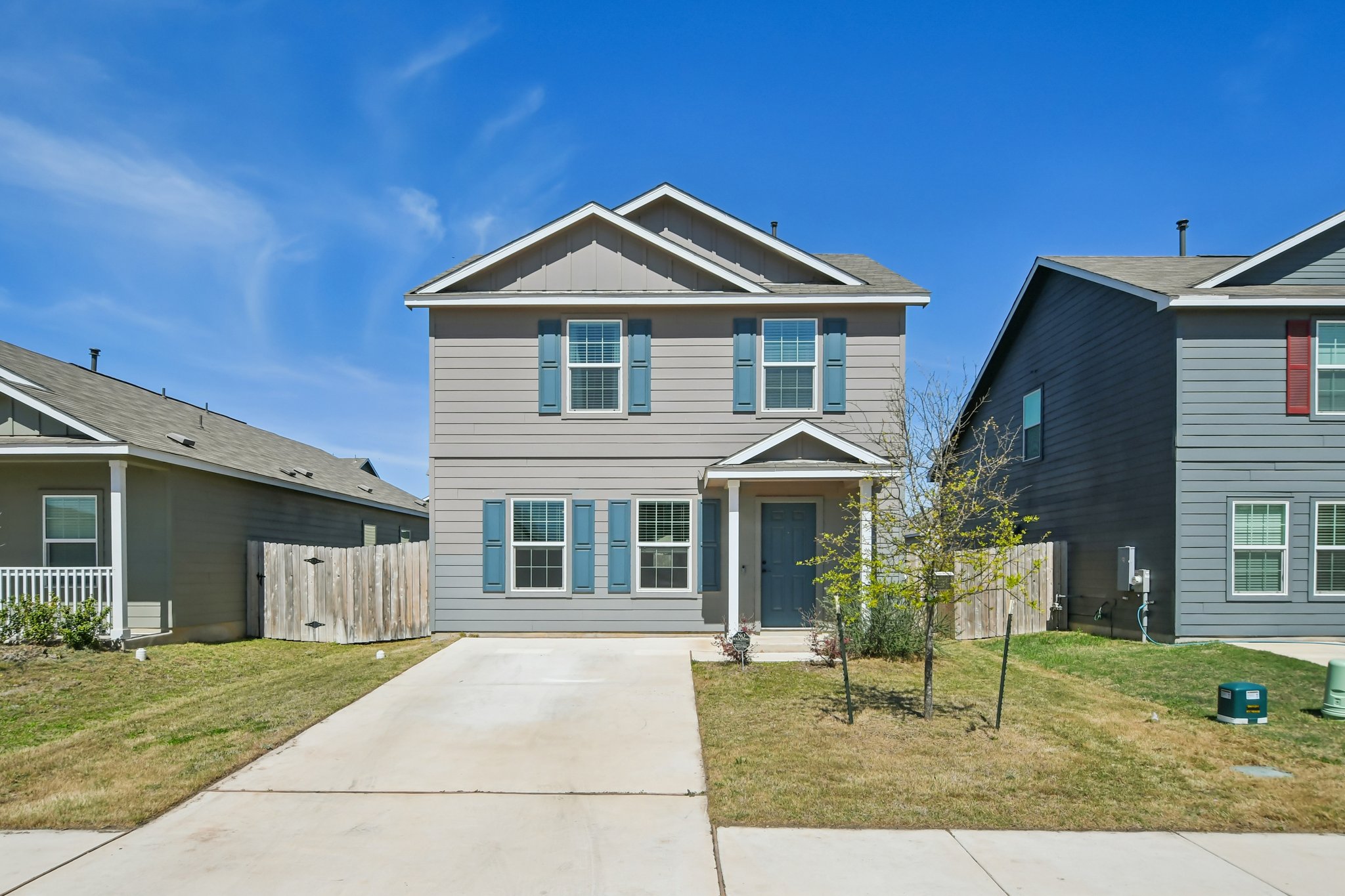 14116 Mussel Run Elgin, TX 78621 - Photo 2 of 40 Traditional-style house with board and batten siding, driveway, and a gate