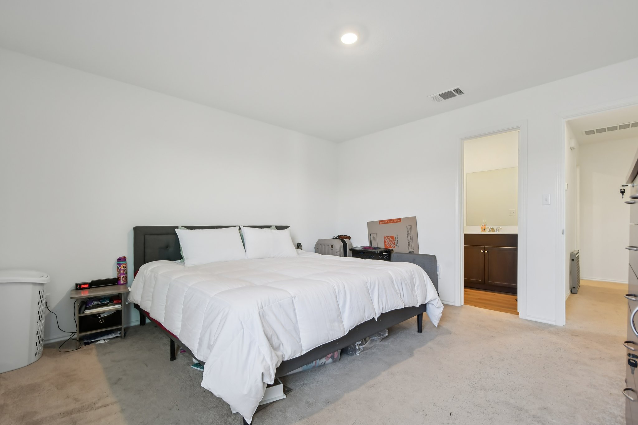 14116 Mussel Run Elgin, TX 78621 - Photo 23 of 40 Bedroom with light colored carpet and ensuite bathroom