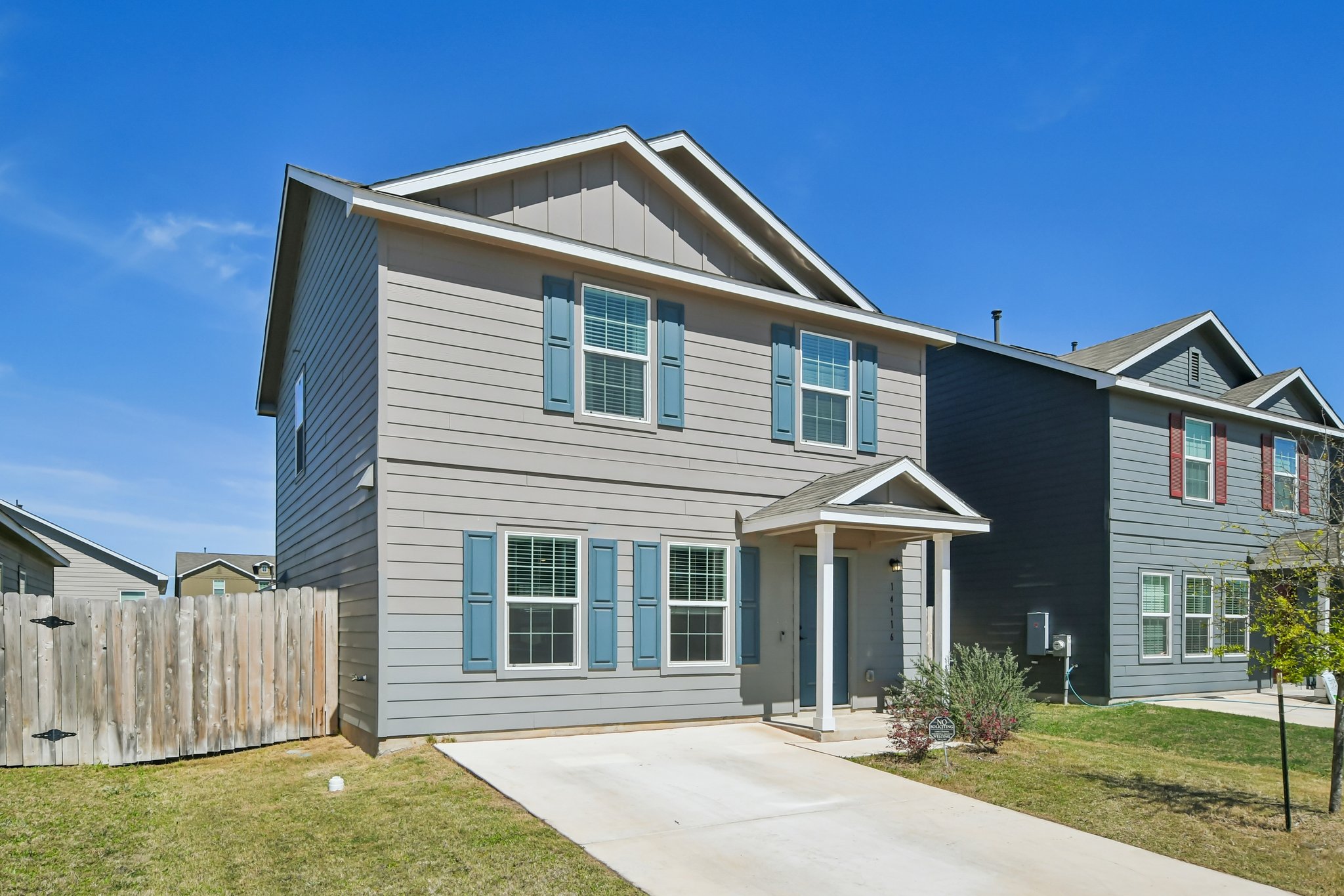 14116 Mussel Run Elgin, TX 78621 - Photo 33 of 40 View of front facade with board and batten siding and concrete driveway