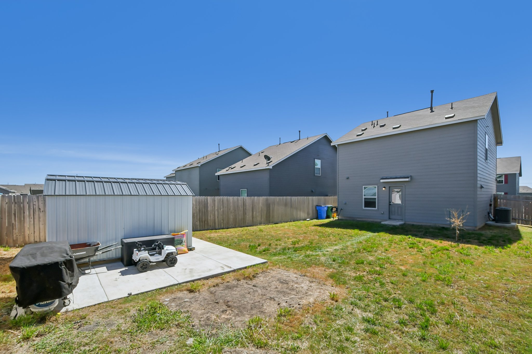 14116 Mussel Run Elgin, TX 78621 - Photo 37 of 40 Rear view of property with a fenced backyard, an outdoor structure, and a patio area