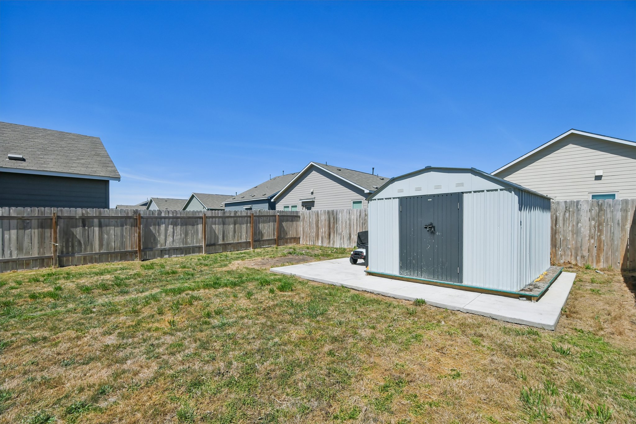 14116 Mussel Run Elgin, TX 78621 - Photo 39 of 40 Fenced backyard featuring a storage unit and a residential view