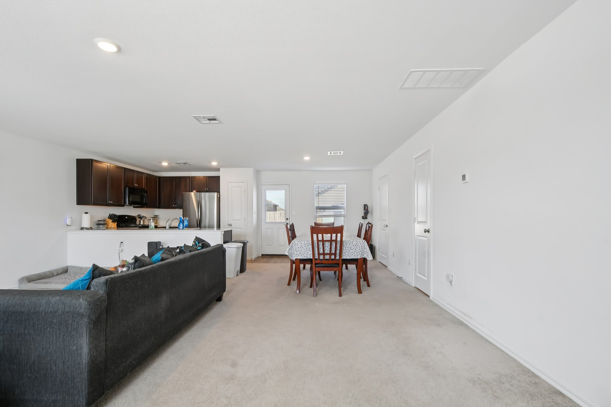 14116 Mussel Run Elgin, TX 78621 - Photo 6 of 40 Living area with light carpet and recessed lighting
