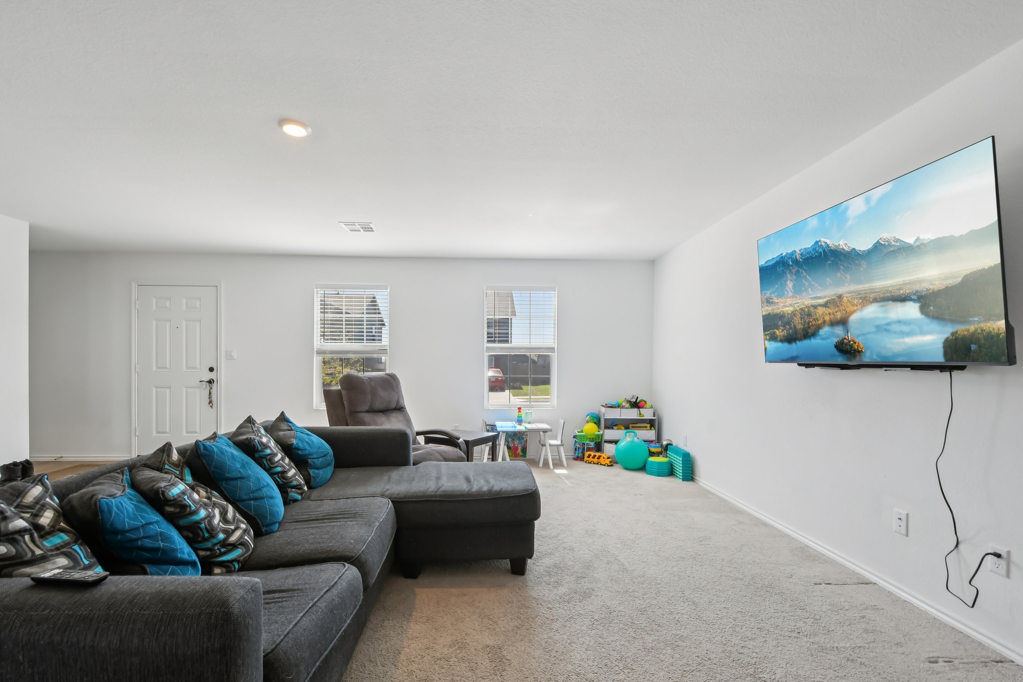 14116 Mussel Run Elgin, TX 78621 - Photo 8 of 40 Carpeted living room with baseboards
