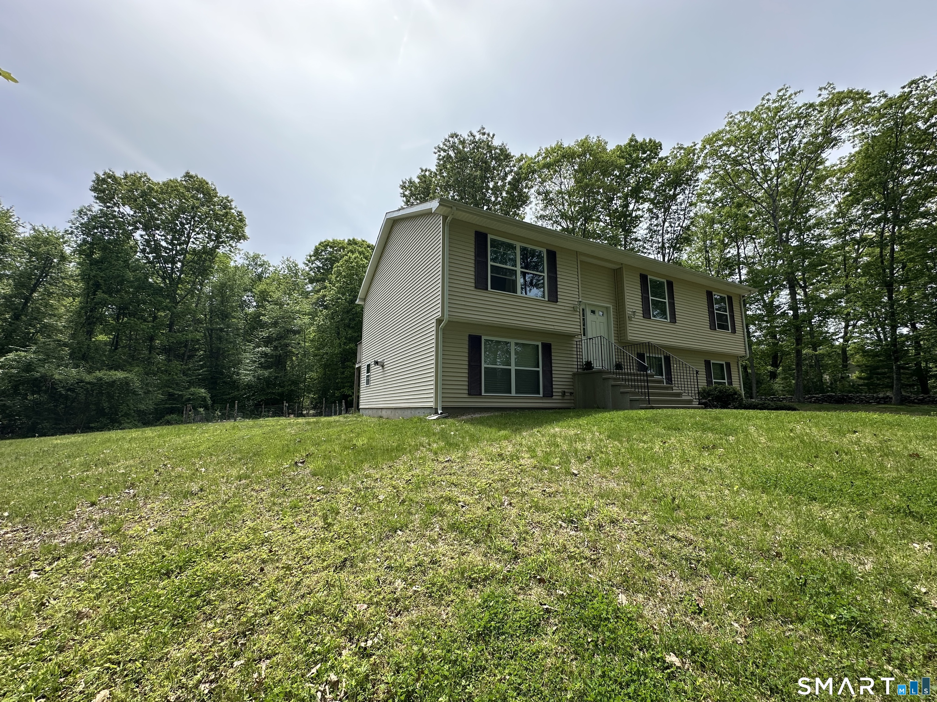 116 Tatnic Hill Road Brooklyn, CT 06234 - Photo 6 of 27 a house view with a garden space