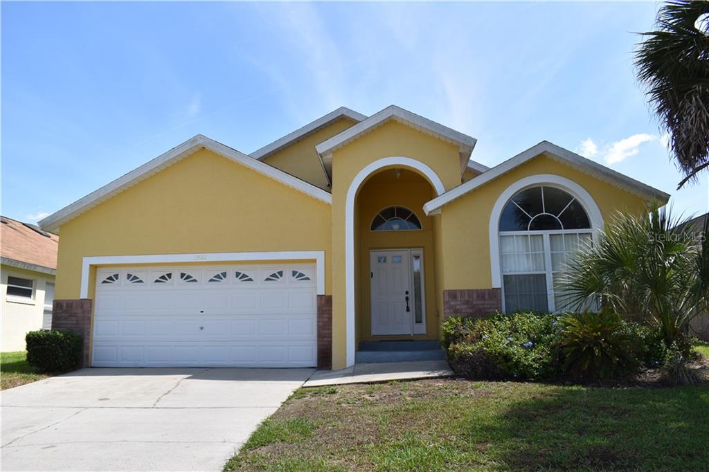 2602 Oneida Loop Kissimmee, FL 34747 - Photo 1 of 1 a front view of a house with garden