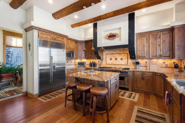a large kitchen with a table and chairs