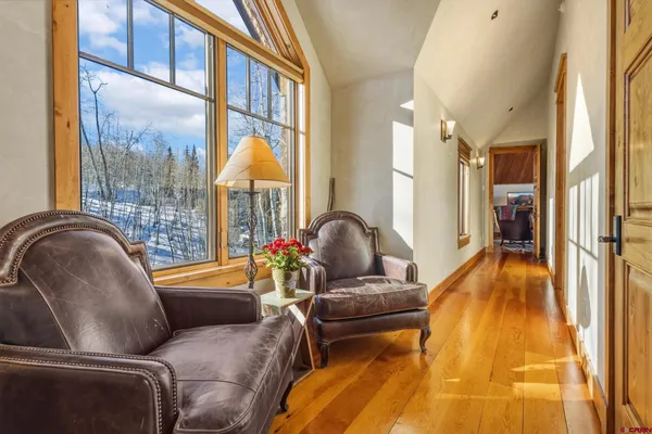 a living room filled with furniture and floor to ceiling windows