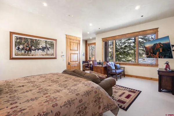 a bedroom with furniture and a large window