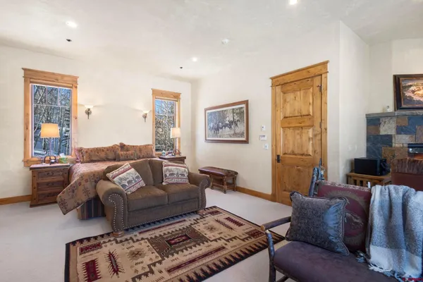 a living room with furniture ceiling fan and a window
