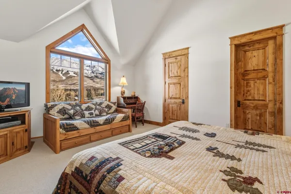 a bedroom with a bed and a couch