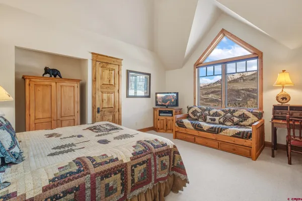 a bedroom with a bed and a large window