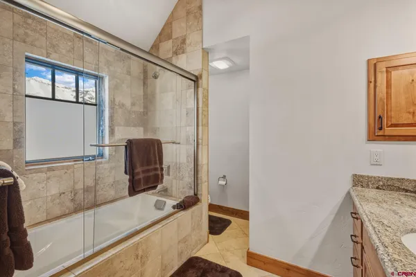 a bathroom with a tub sink and mirror
