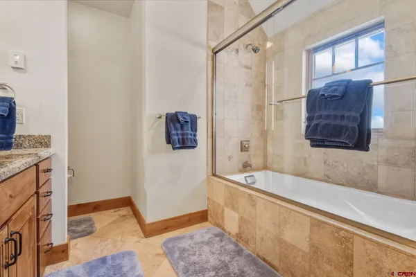 a spacious bathroom with a tub shower and sink