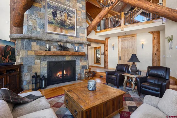 a living room with furniture a flat screen tv and a fireplace