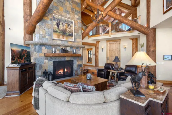 a living room with furniture a fireplace and a flat screen tv