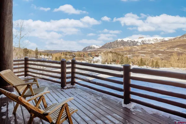 a view of a balcony with wooden benches