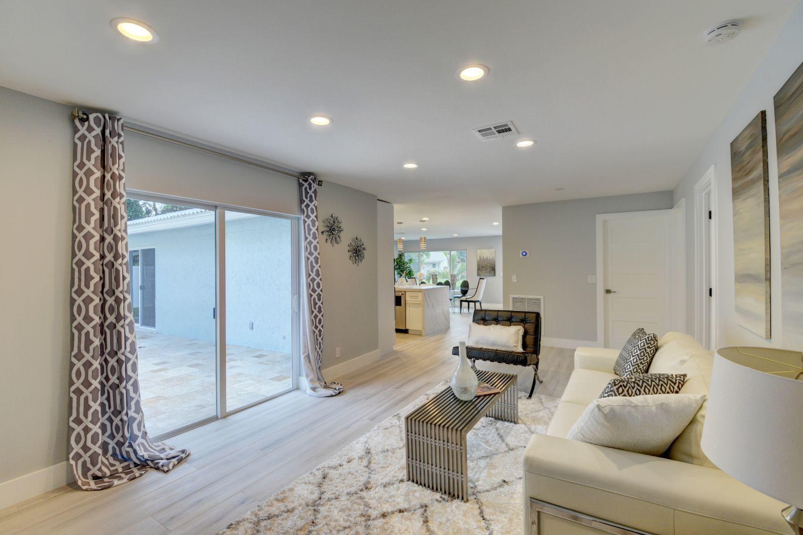 709 Sunshine Drive Delray Beach, FL 33444 - Photo 11 of 25 a living room with furniture a window and a wooden floor