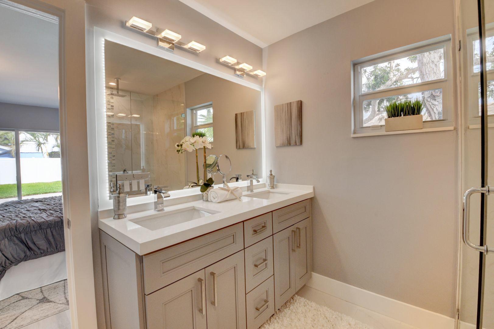 709 Sunshine Drive Delray Beach, FL 33444 - Photo 15 of 25 a bathroom with a sink vanity and a mirror
