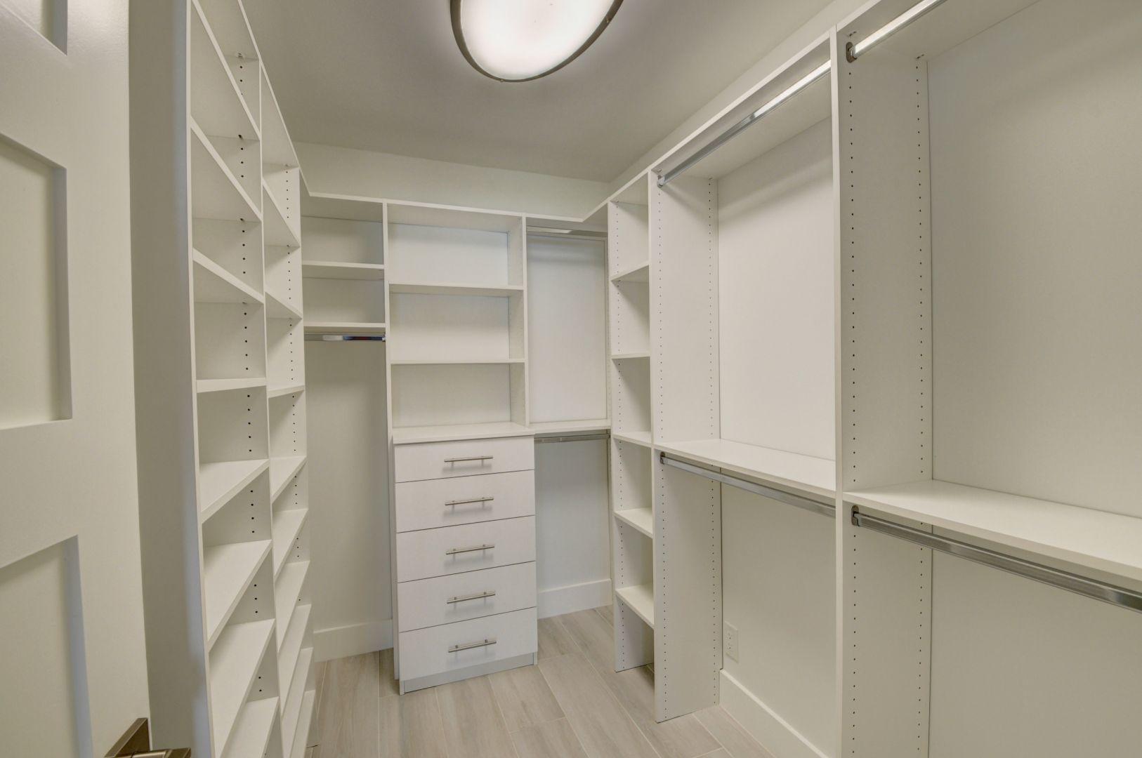 709 Sunshine Drive Delray Beach, FL 33444 - Photo 16 of 25 a view of walk in closet with empty racks