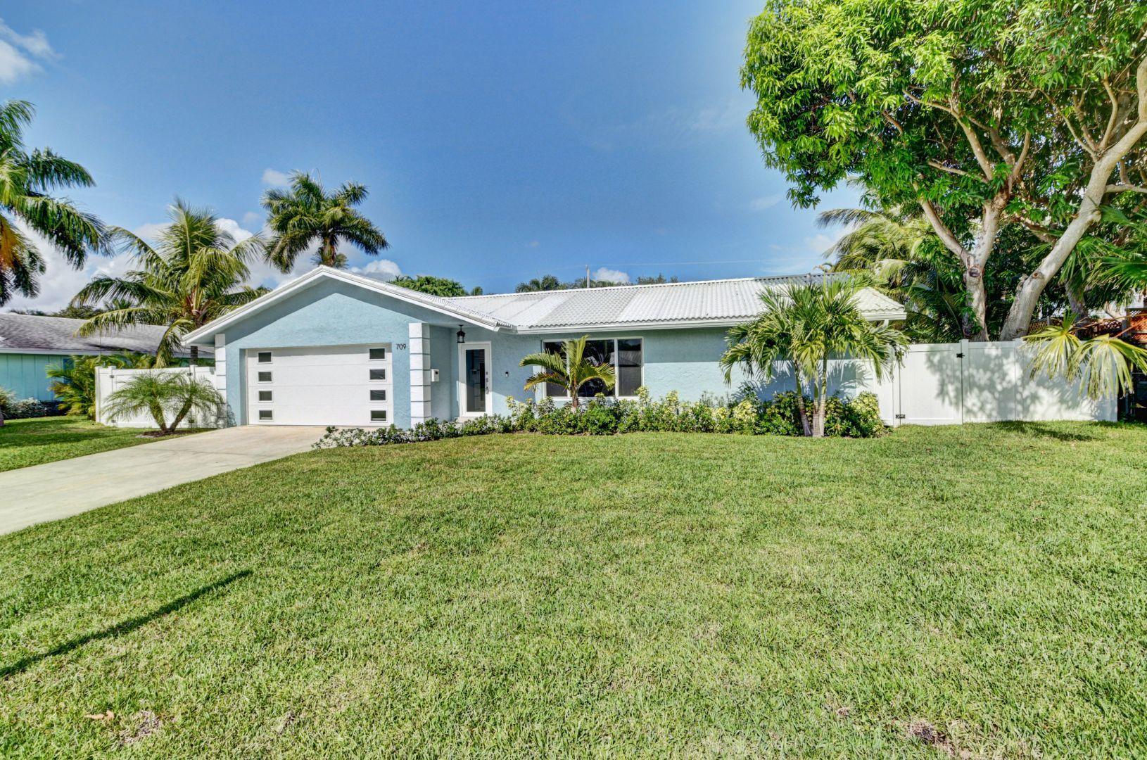 709 Sunshine Drive Delray Beach, FL 33444 - Photo 2 of 25 a view of an house with backyard space and garden