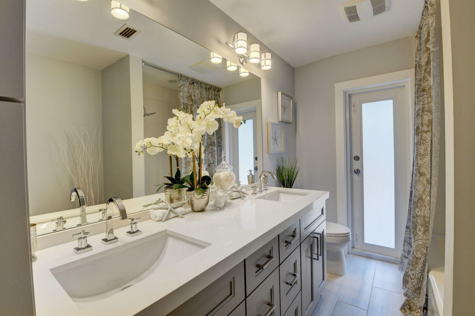 709 Sunshine Drive Delray Beach, FL 33444 - Photo 21 of 25 a bathroom with a sink double vanity and a mirror