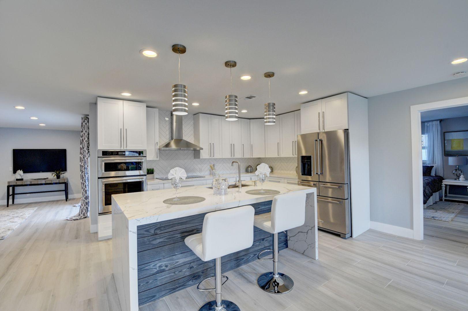 709 Sunshine Drive Delray Beach, FL 33444 - Photo 4 of 25 a kitchen with a sink stainless steel appliances and cabinets