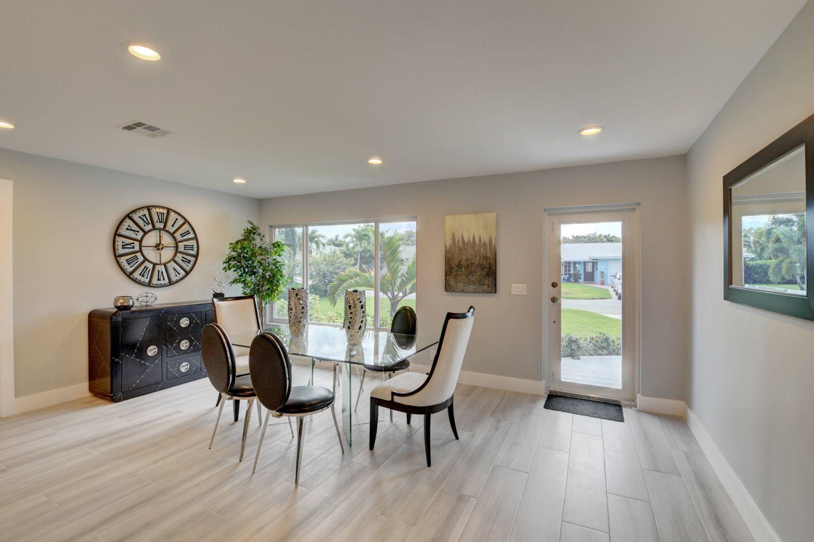 709 Sunshine Drive Delray Beach, FL 33444 - Photo 9 of 25 a view of a dining room with furniture window and wooden floor