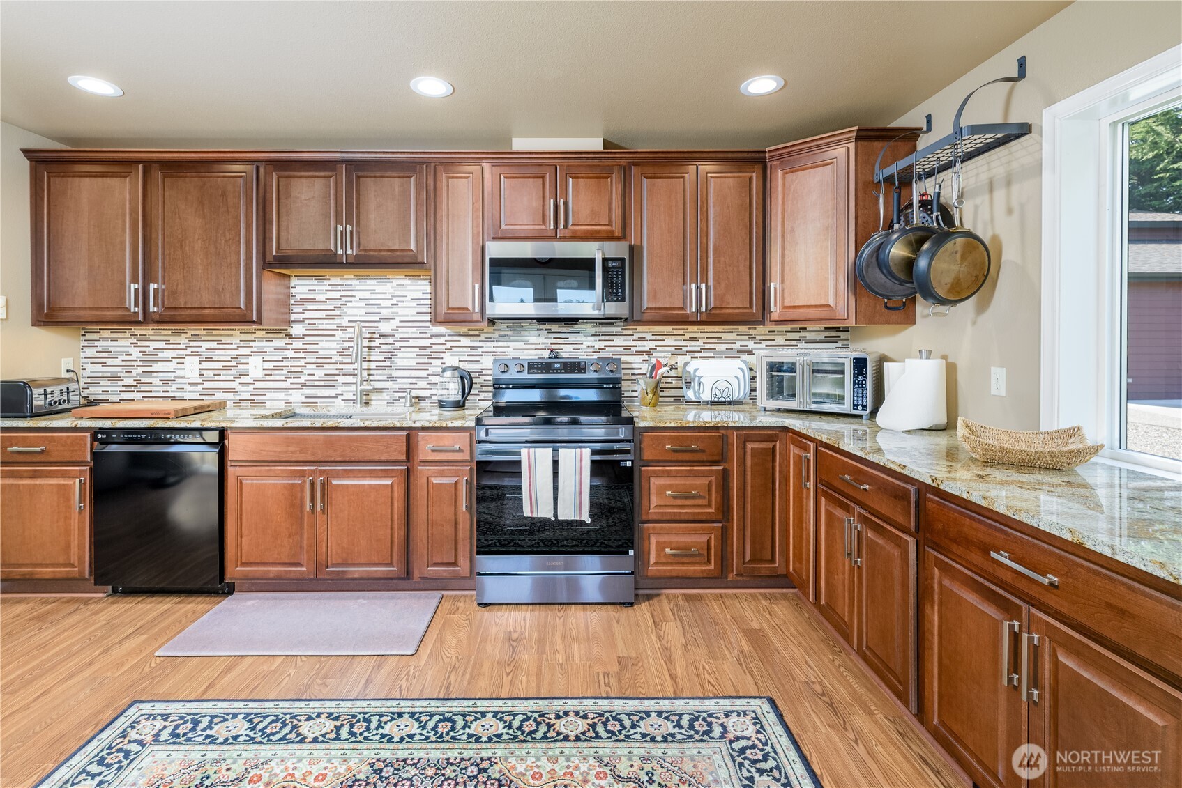 3718 Sequim-Dungeness Way Sequim, WA 98382 - Photo 12 of 40 a kitchen with a stove a sink and a microwave