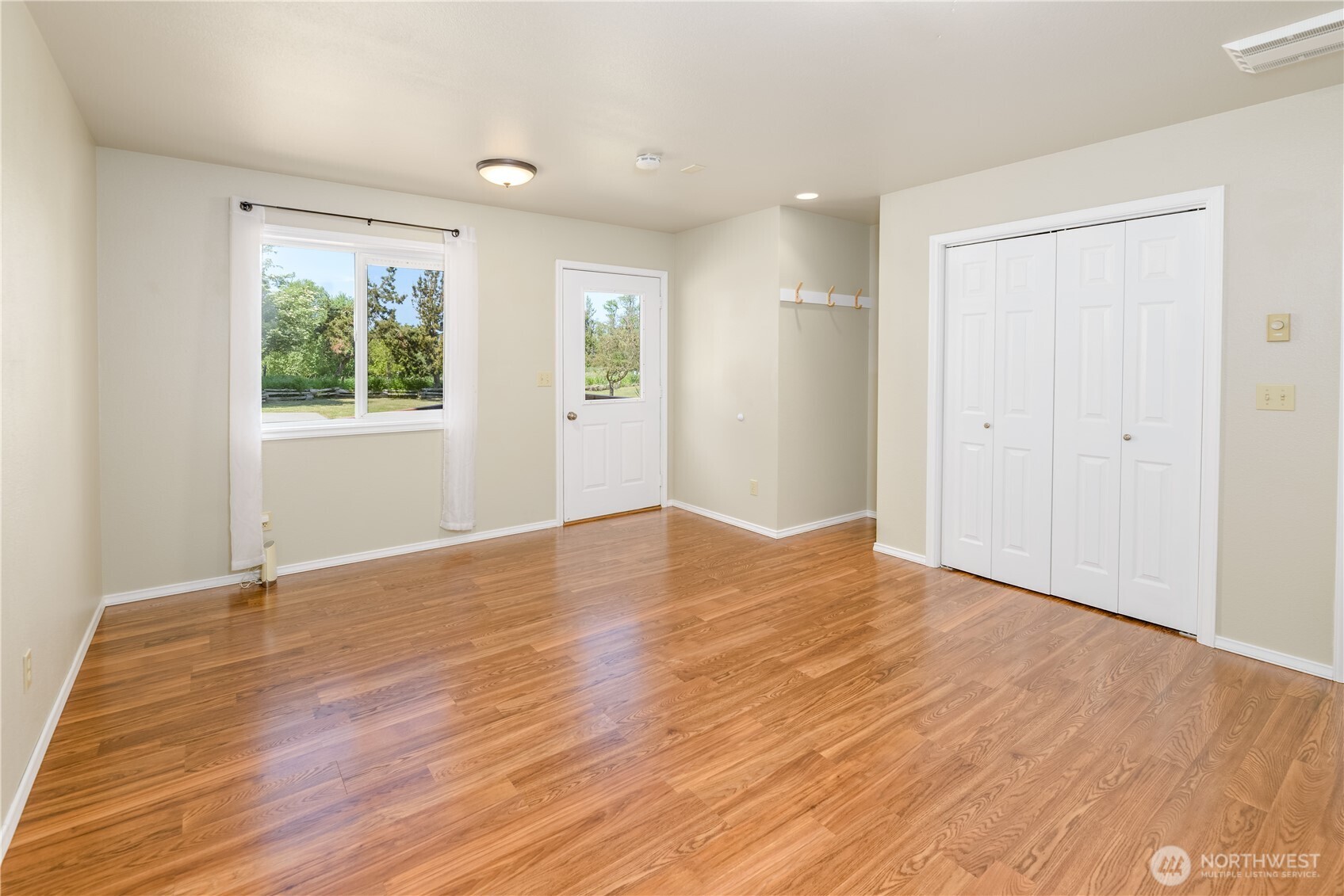 3718 Sequim-Dungeness Way Sequim, WA 98382 - Photo 18 of 40 a view of empty room with wooden floor and fan