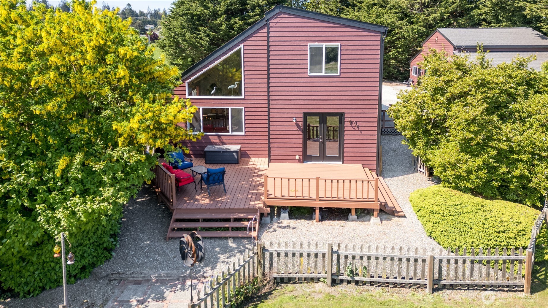 3718 Sequim-Dungeness Way Sequim, WA 98382 - Photo 32 of 40 a view of a house with a small deck and a garden