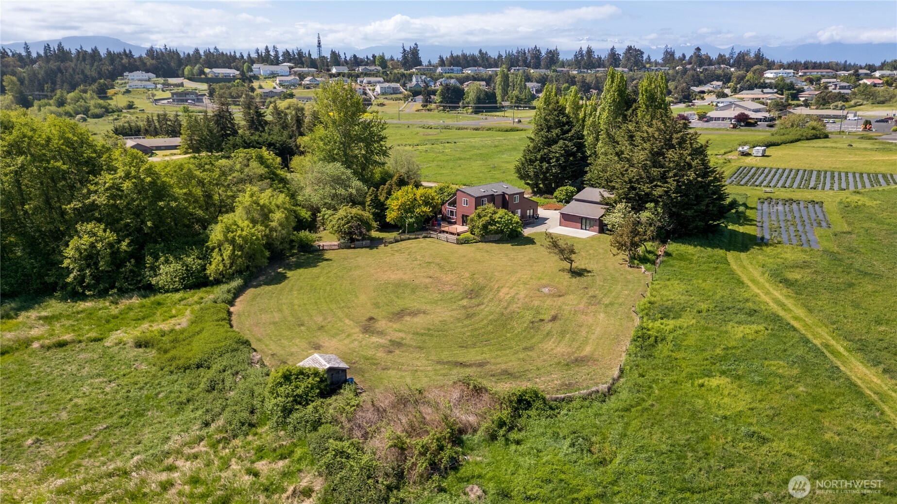 3718 Sequim-Dungeness Way Sequim, WA 98382 - Photo 35 of 40 an aerial view of residential houses with outdoor space and trees