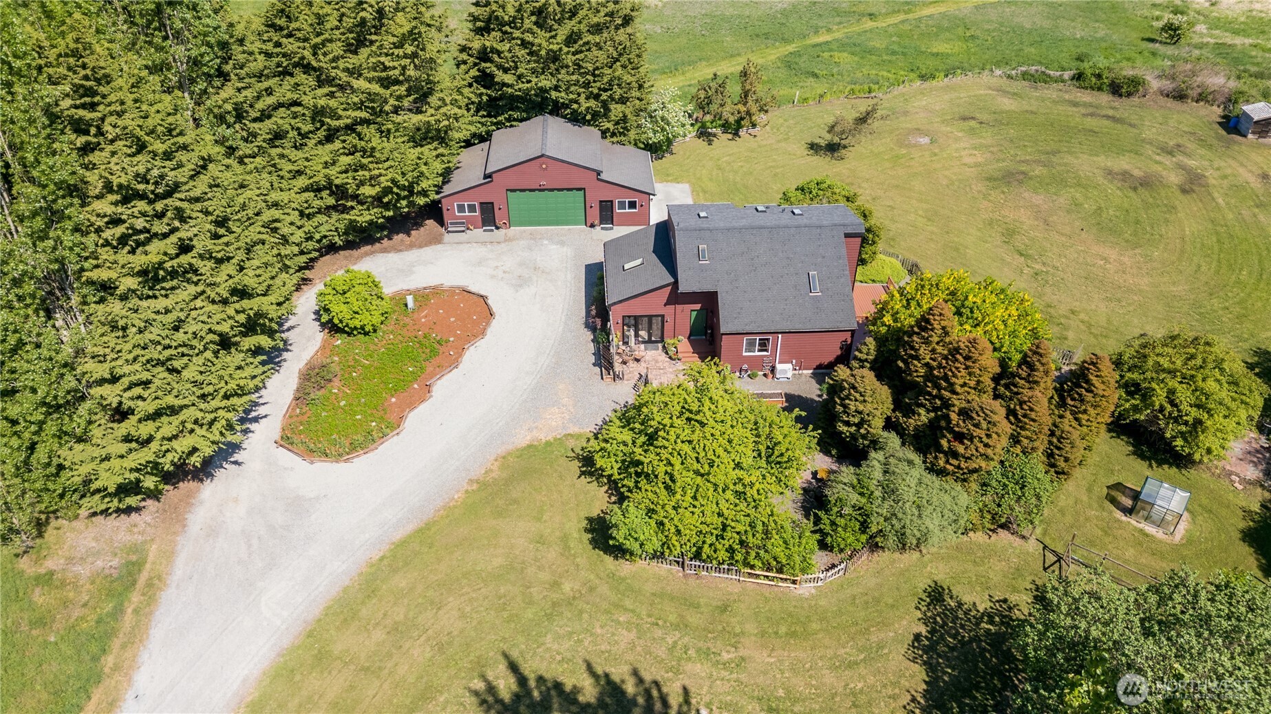 3718 Sequim-Dungeness Way Sequim, WA 98382 - Photo 4 of 40 an aerial view of a house with a yard and lake view