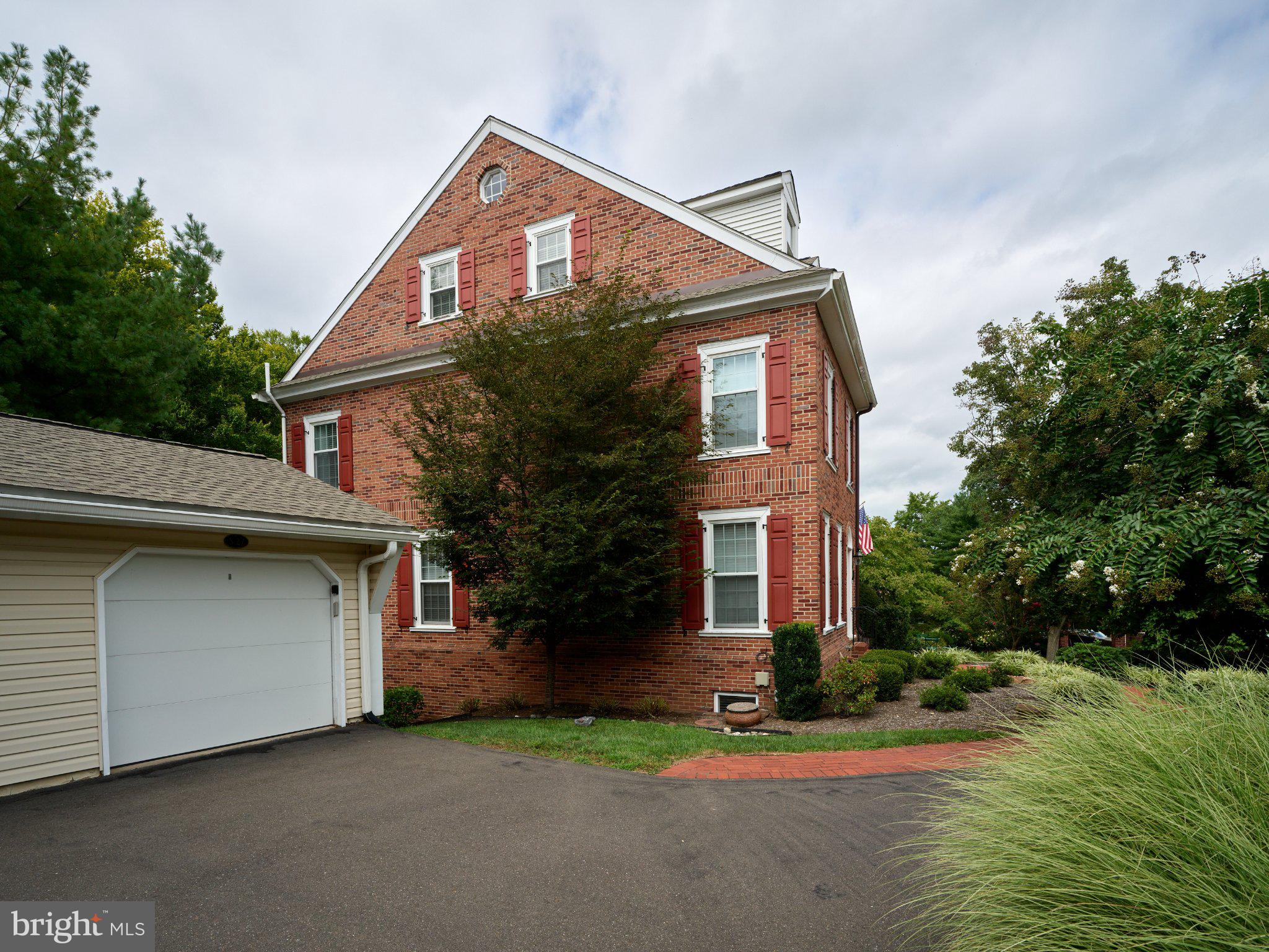 27 Sentinel Road, Unit 139 Washington Crossing, PA 18977 - Photo 35 of 37 Charming brick home with lush greenery.