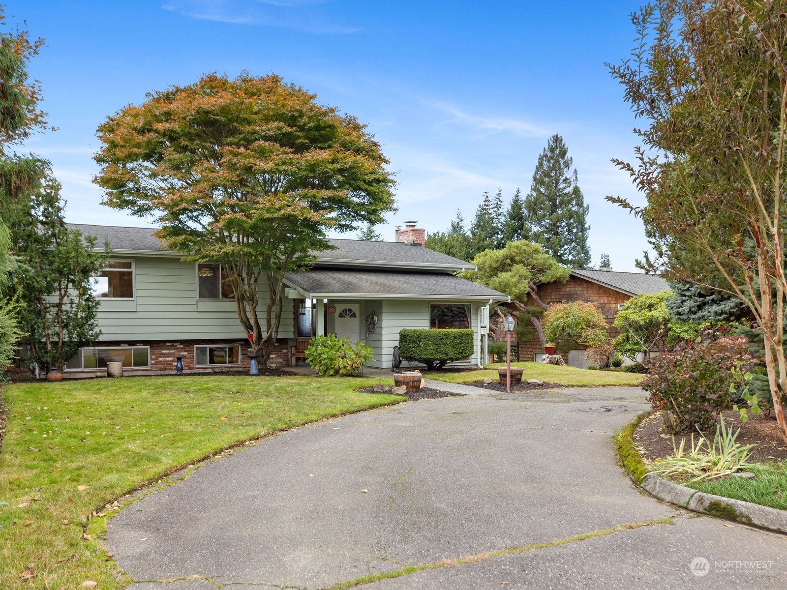 358 Heather Road Everett, WA 98203 - Photo 38 of 39 a front view of a house with a garden and trees