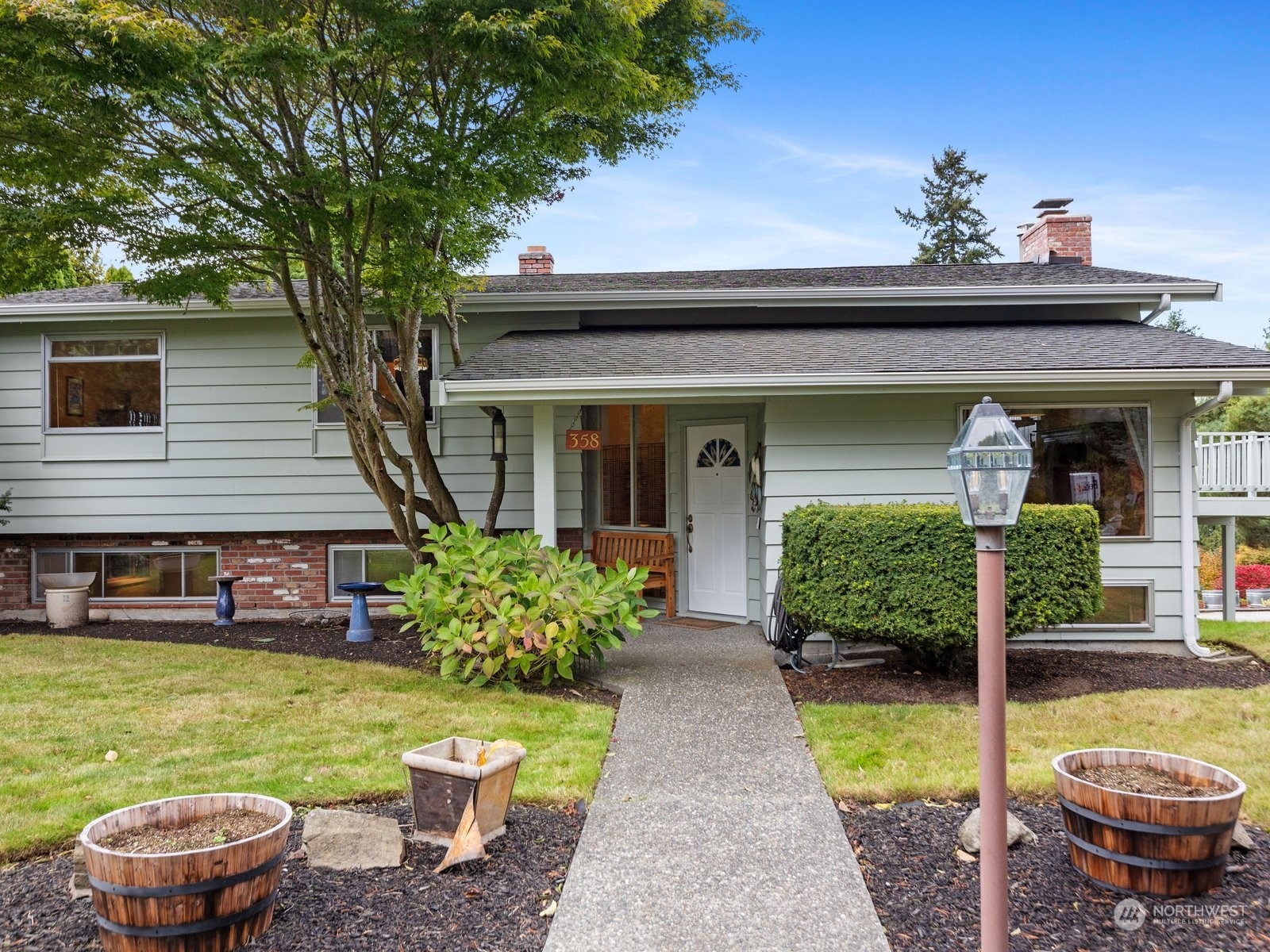 358 Heather Road Everett, WA 98203 - Photo 8 of 39 a front view of a house with a yard potted plants and a large tree