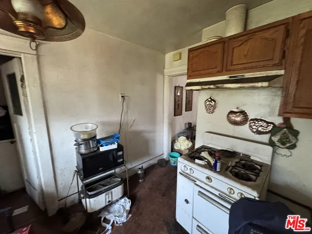 a kitchen with a stove and a refrigerator