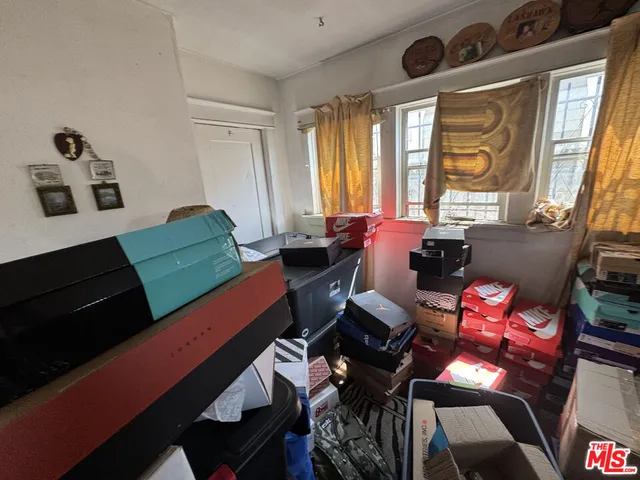 a living room with furniture and large windows