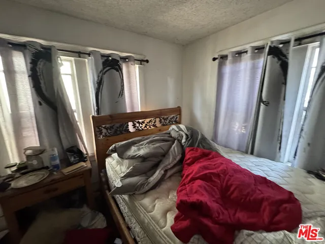 a bedroom with a bed and a mirror