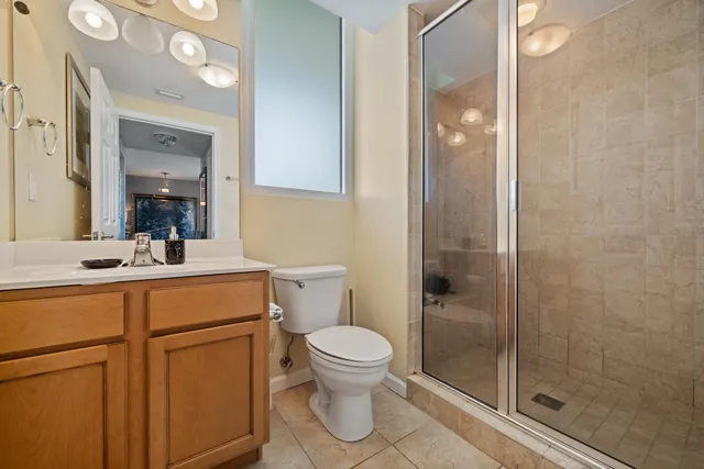 a bathroom with a toilet a sink and a mirror